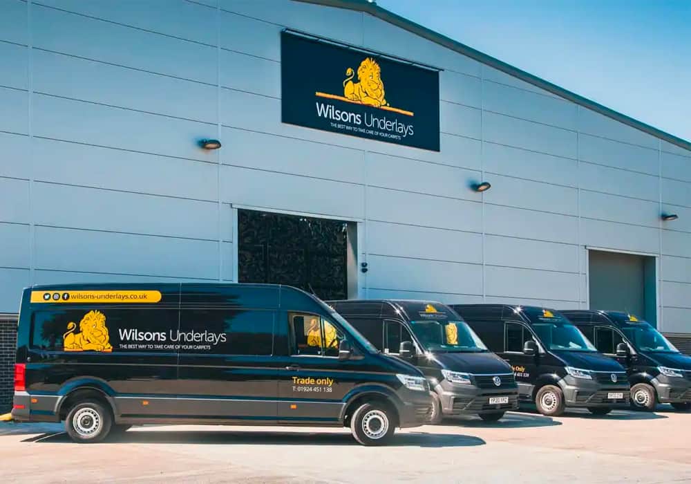 Wilsons Underlays warehouse with vans parked outside