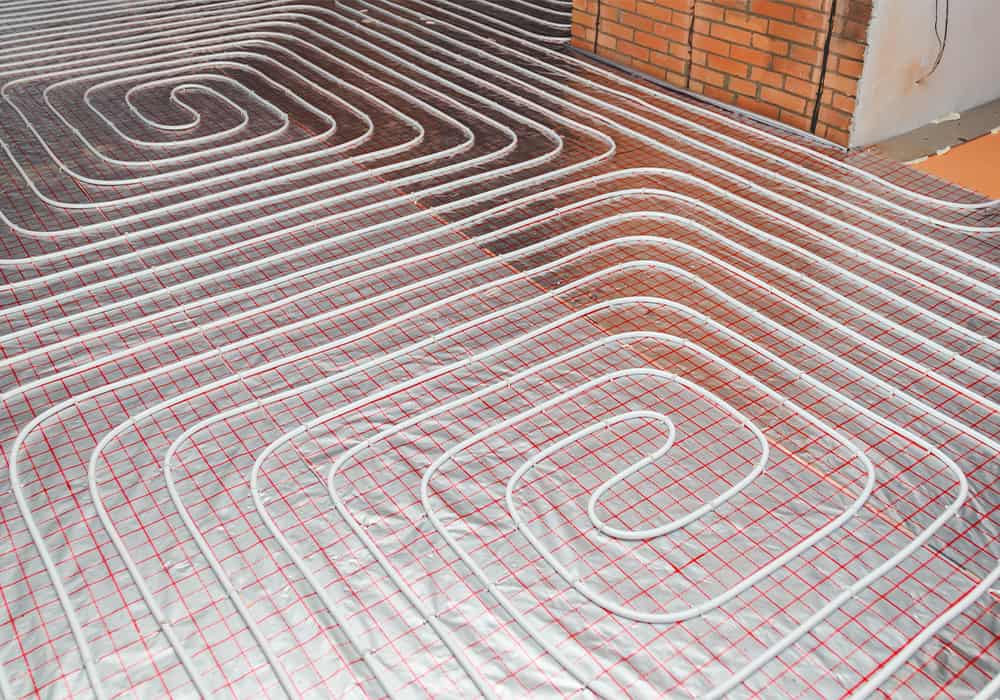 Wet underfloor heating system pipes pinned to insulation