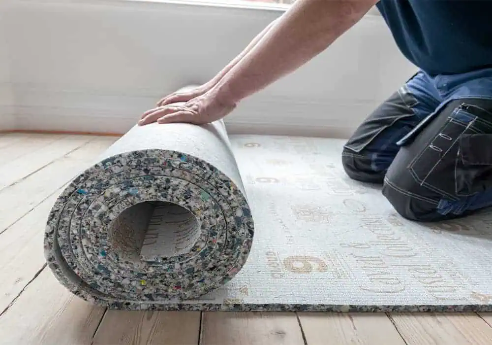 Man rolling our carpet underlay ready for fitting