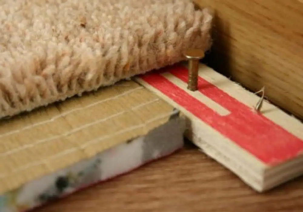 Carpet gripper, underlay and carpet on a wood subfloor