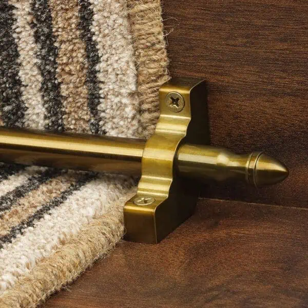 Homepride Stair Carpet Runner Rod in Bronze with a striped carpet on wooden stairs